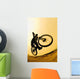 Silhouette Of A Cyclist Against A Yellow Sky Wall Mural