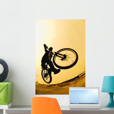 Silhouette Cyclist against Yellow Wall Mural shown on a wall