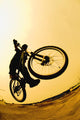 Silhouette Of A Cyclist Against A Yellow Sky Wall Mural