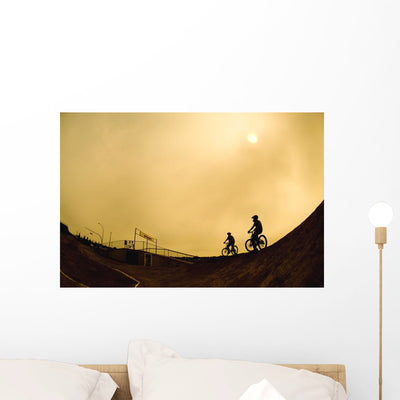 Two Cyclists Wall Mural shown on a wall