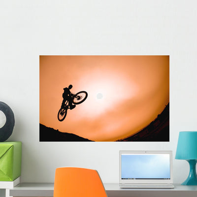 Silhouette Stunt Cyclist Wall Mural shown on a wall