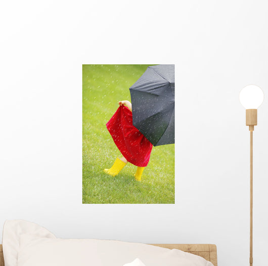 A Little Girl Walking In The Rain While Holding An Umbrella Wall Mural