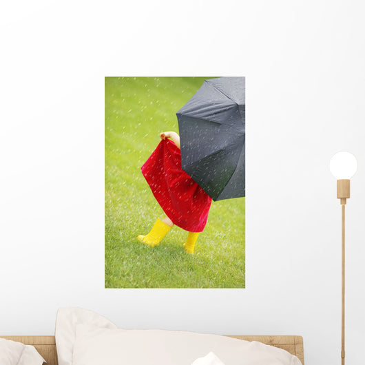 A Little Girl Walking In The Rain While Holding An Umbrella Wall Mural