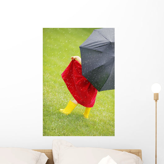 A Little Girl Walking In The Rain While Holding An Umbrella Wall Mural
