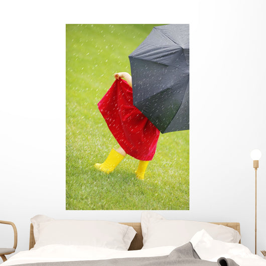 A Little Girl Walking In The Rain While Holding An Umbrella Wall Mural