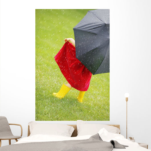A Little Girl Walking In The Rain While Holding An Umbrella Wall Mural