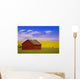 A Red Farm Building Against A Canola Field Wall Mural