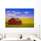 A Red Farm Building Against A Canola Field Wall Mural