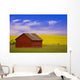 A Red Farm Building Against A Canola Field Wall Mural