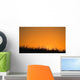 A Grassy Field With The Sun Setting Behind It Wall Mural