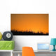 A Grassy Field With The Sun Setting Behind It Wall Mural