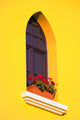 A Window In A Bright Yellow Wall Wall Mural