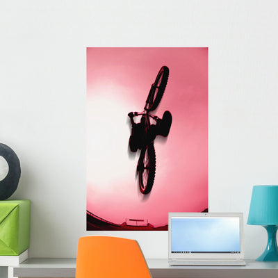 Silhouette Stunt Bike Rider Wall Mural shown on a wall