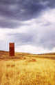A Grain Elevator In A Field Wall Mural