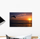 Silhouette Of Bottlenose Dolphin Leaping Over Ocean At Sunset Wall Mural