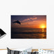 Silhouette Of Bottlenose Dolphin Leaping Over Ocean At Sunset Wall Mural