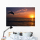 Silhouette Of Bottlenose Dolphin Leaping Over Ocean At Sunset Wall Mural