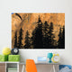 Tree Silhouettes In Front Of Cliff Face Wall Mural