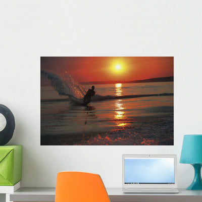 Waterskiing Sunset Wall Mural shown on a wall