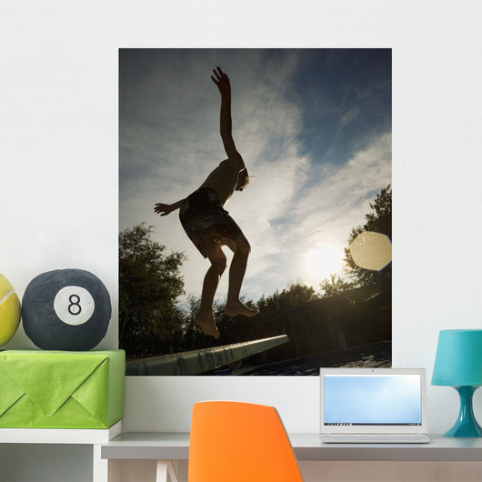 Boy Jumping Off Diving Board Wall Mural