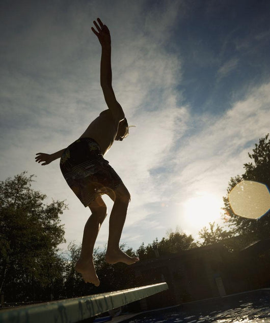 Boy Jumping Off Diving Board Wall Mural