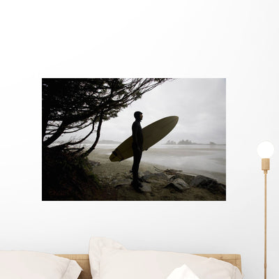 Surfer Observing Water from Wall Mural shown on a wall