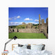 Old Ruins Of An Abbey With A Castle In The Background Wall Mural