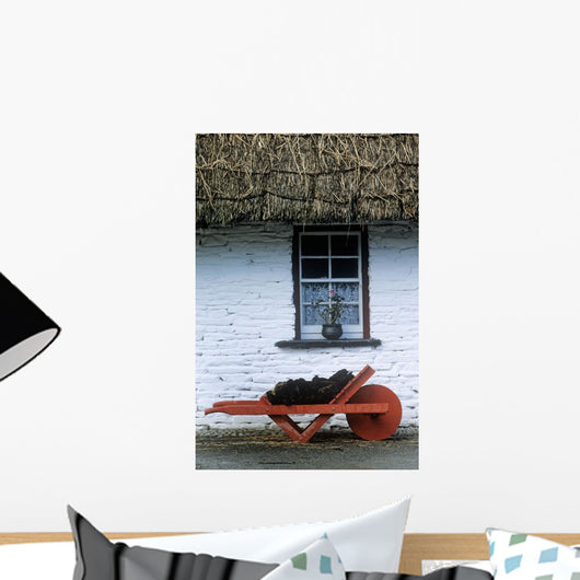 Wheelbarrow In Front Of A Window Of A Cottage Wall Mural