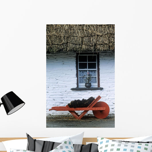 Wheelbarrow In Front Of A Window Of A Cottage Wall Mural