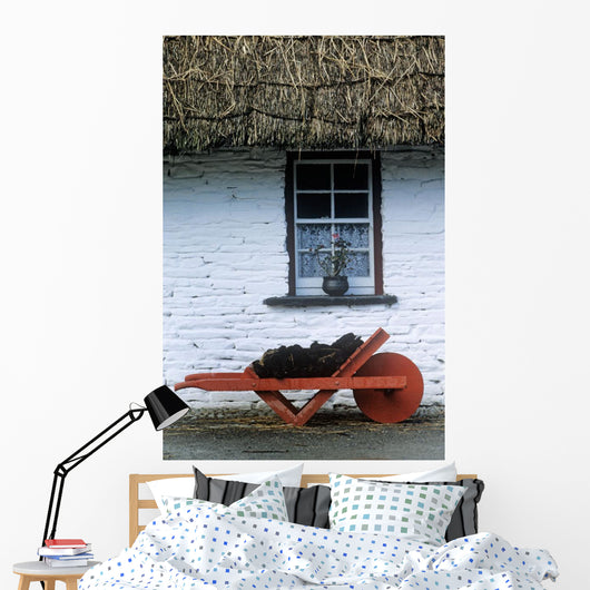 Wheelbarrow In Front Of A Window Of A Cottage Wall Mural