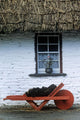 Wheelbarrow In Front Of A Window Of A Cottage Wall Mural