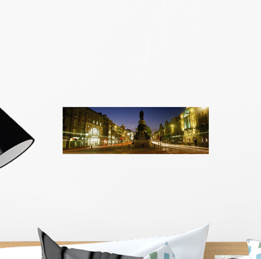 Statue Of A Man On A Pedestal On The Street At Dusk Wall Mural