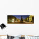 Statue Of A Man On A Pedestal On The Street At Dusk Wall Mural