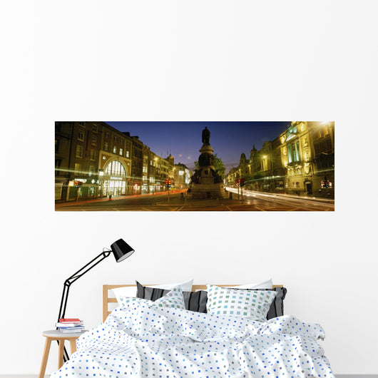 Statue Of A Man On A Pedestal On The Street At Dusk Wall Mural
