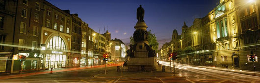 Statue Of A Man On A Pedestal On The Street At Dusk Wall Mural