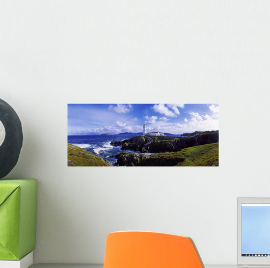 Waves Breaking On The Coast With A Light House In Background Wall Mural