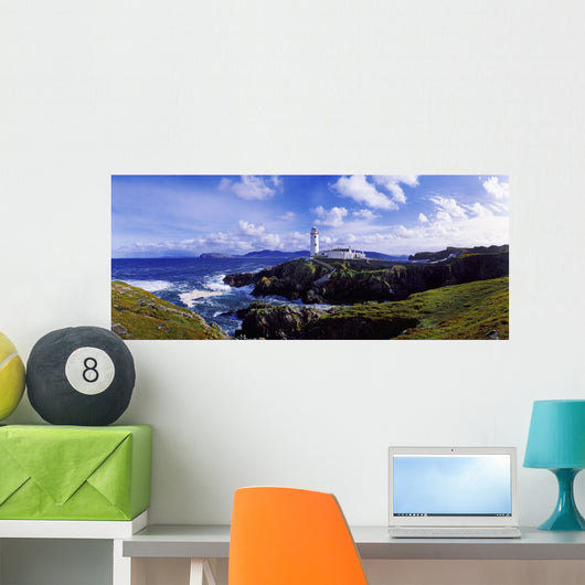 Waves Breaking On The Coast With A Light House In Background Wall Mural