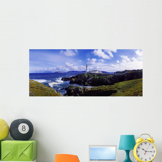 Waves Breaking On The Coast With A Light House In Background Wall Mural