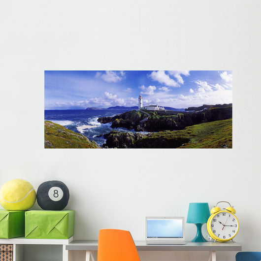 Waves Breaking On The Coast With A Light House In Background Wall Mural