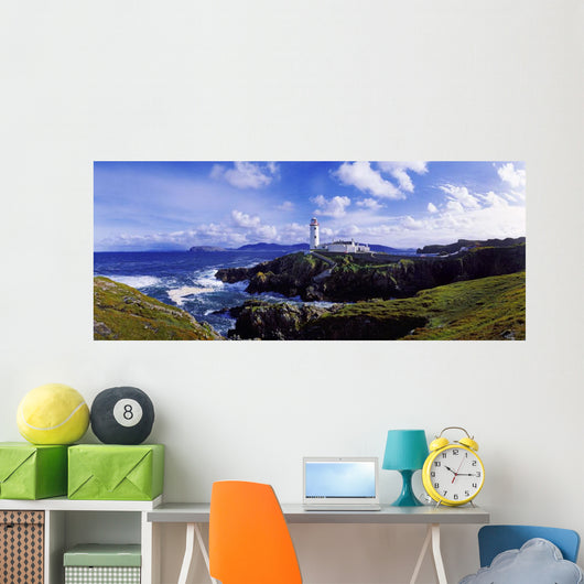 Waves Breaking On The Coast With A Light House In Background Wall Mural