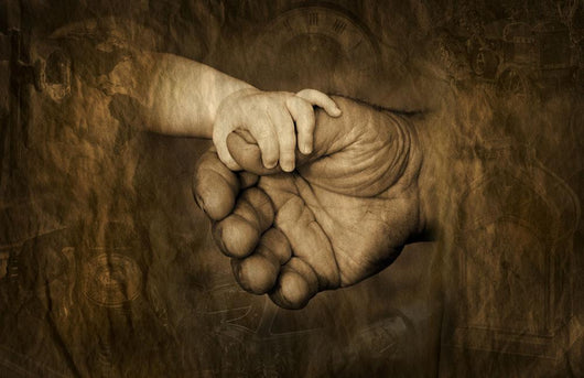 Child's Hand Holding Adult Hands Wall Mural