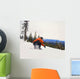 Snowboarder Crouching Down Low As He Descends Snow Hill Wall Mural
