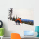 Snowboarder Crouching Down Low As He Descends Snow Hill Wall Mural