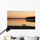 A Bench Silhouetted At Sunset Near The Lake Wall Mural