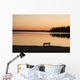 A Bench Silhouetted At Sunset Near The Lake Wall Mural