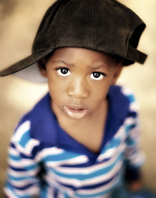 Boy Wearing Over Sized Hat Sideways Wall Mural