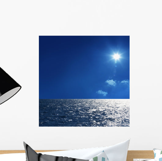 a background image of an open sea and blue sky Wall Mural