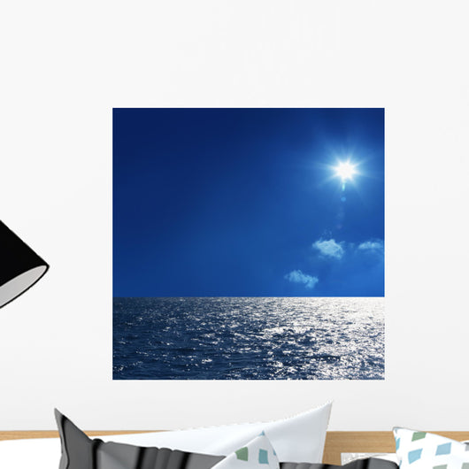 a background image of an open sea and blue sky Wall Mural