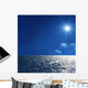 a background image of an open sea and blue sky Wall Mural