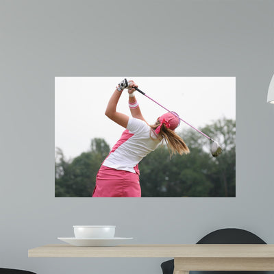 Golf Swing Finish Lady Wall Mural shown on a wall